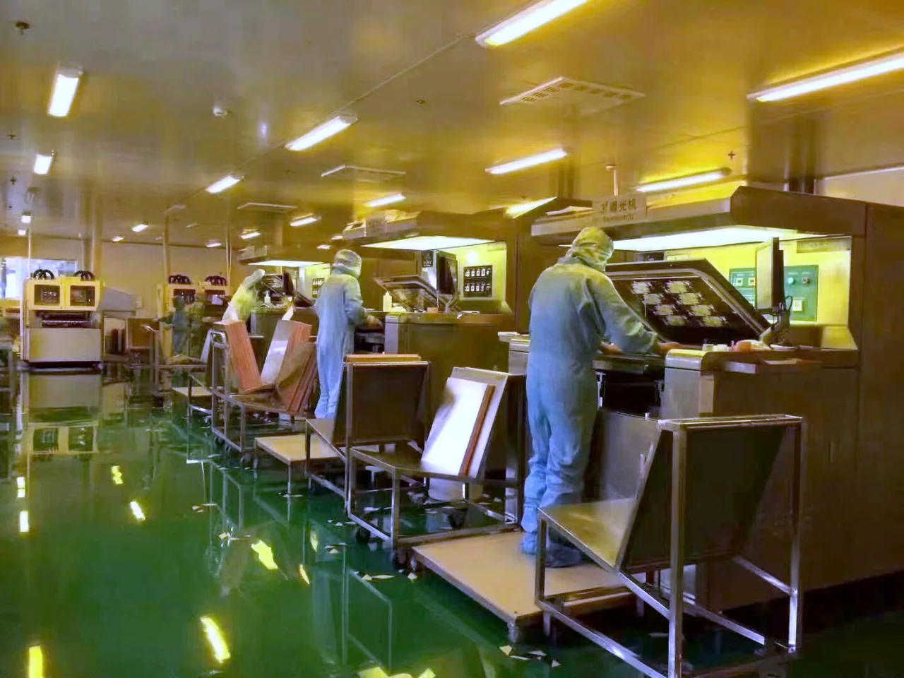 Operators inspecting assembled boards